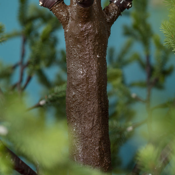 Close-up of a realistic LED tree trunk with natural texture for indoor and outdoor decor.