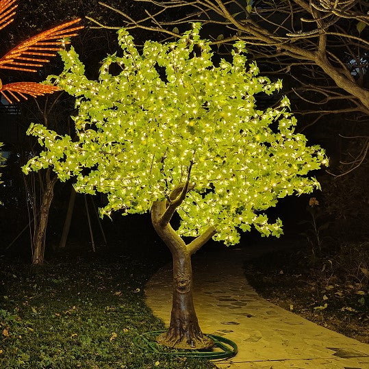 Outdoor LED tree with bright yellow lights and a realistic trunk for garden decor.