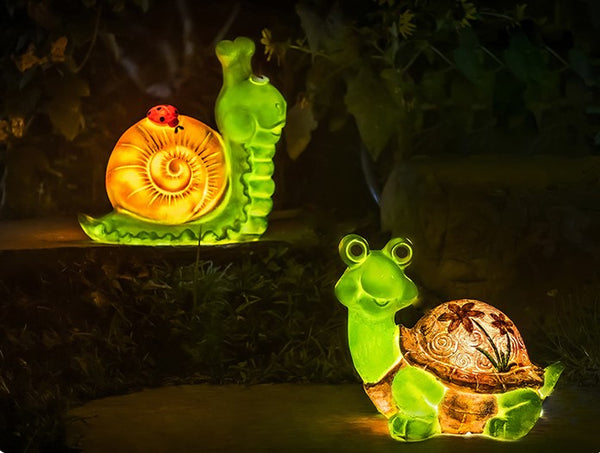 Two glowing snail-shaped lights on a dark background