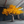 Large artificial tree with yellow leaves in a warehouse setting