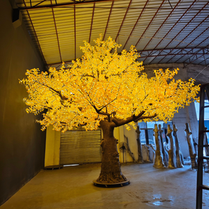 Large illuminated yellow tree in a warehouse setting