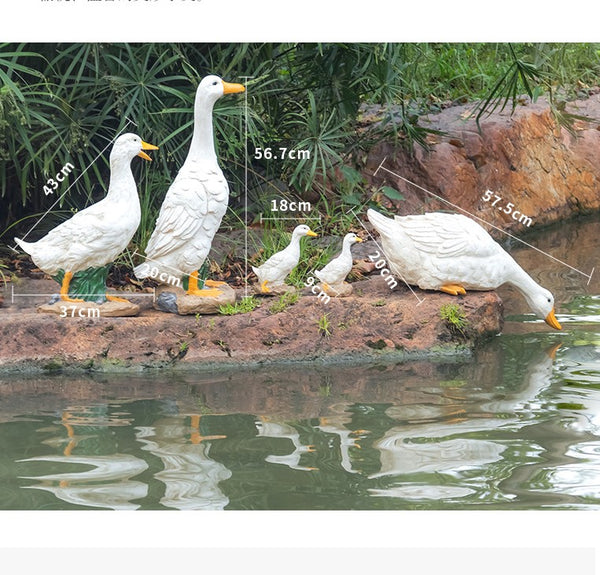 Five white decorative ducks on a rock with measurements indicated, set against a natural background.