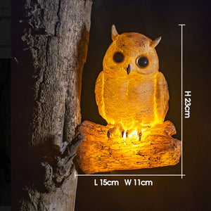 Solar owl garden statue with warm white LED light on tree branch