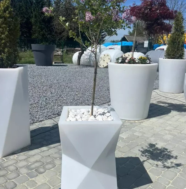 Scale reference image of the tall (27.5 inch) Hourglass planter, demonstrating its size and volume for large decorative plants.