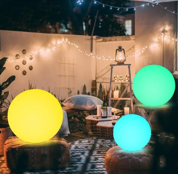 Glowing round lights in a cozy outdoor setting with string lights and furniture.