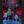 Colorful LED firework tree light fixtures displayed in a large indoor event space, with multiple trees glowing with red, green, blue, and purple lights.