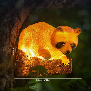 Solar raccoon garden statue with LED light perched on tree branch outdoor decor