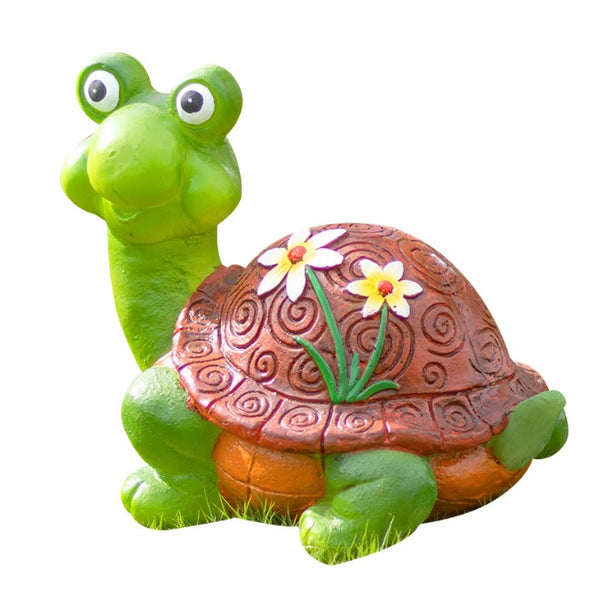 Green turtle figurine with a brown shell featuring floral designs on a white background