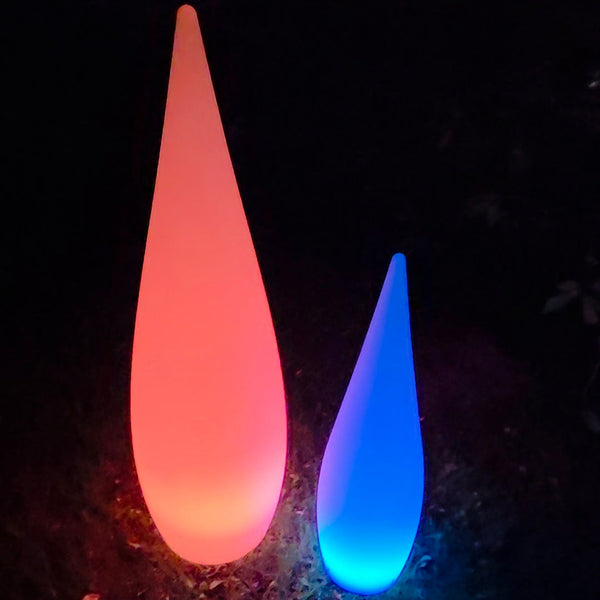 Two colorful LED lamps, one red and one blue, on a dark ground.